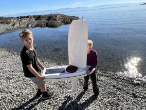 kids launching USV sailboat